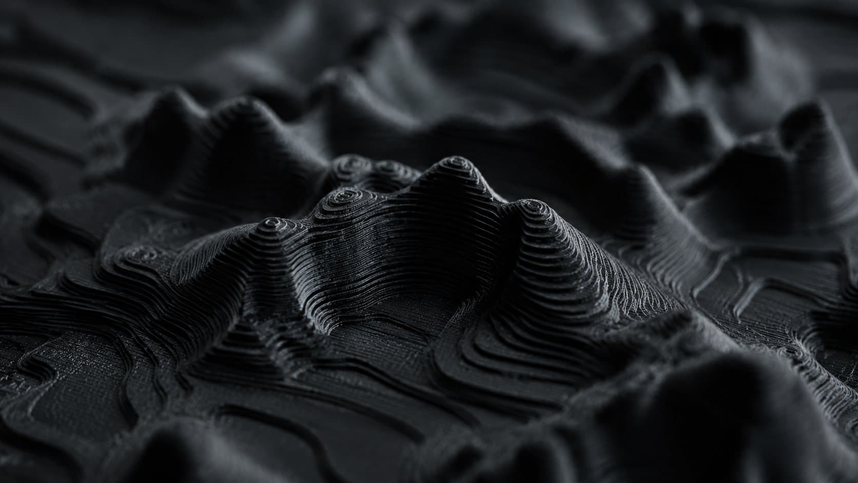 MONUPO visualisation: detail of a printed landscape relief in black material, the print layers following the contours.